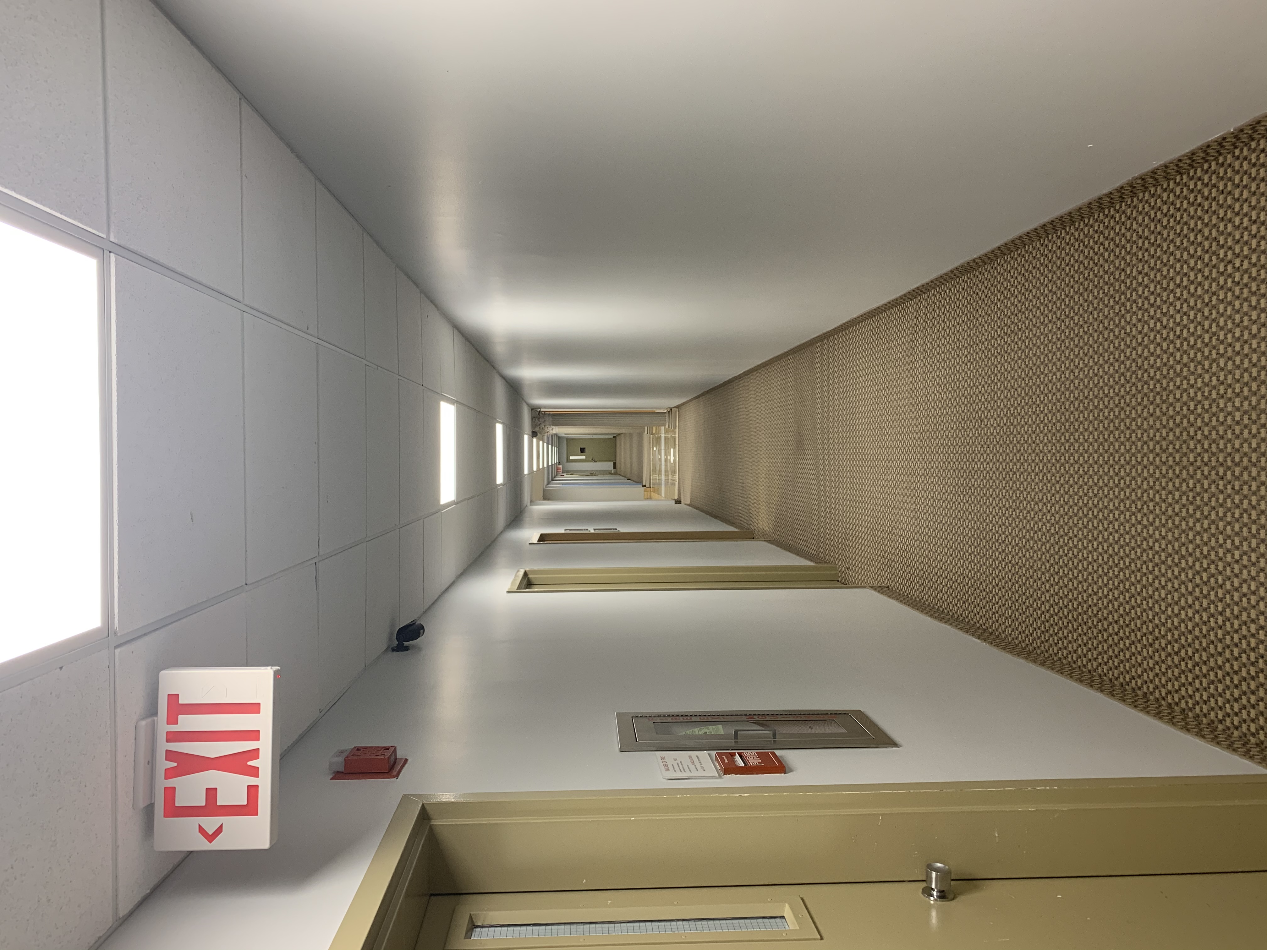 Empty hallway with exit sign